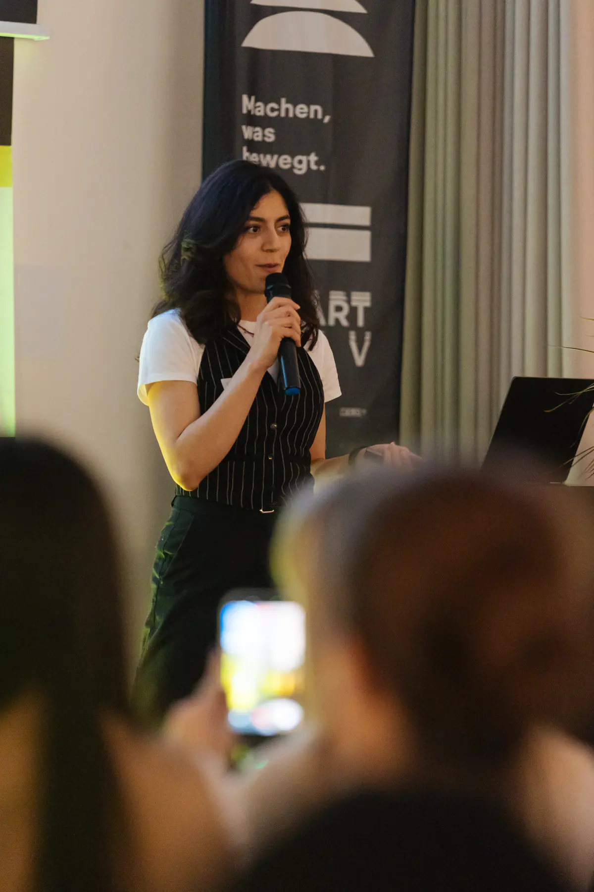 Shideh Heravi speaking on stage